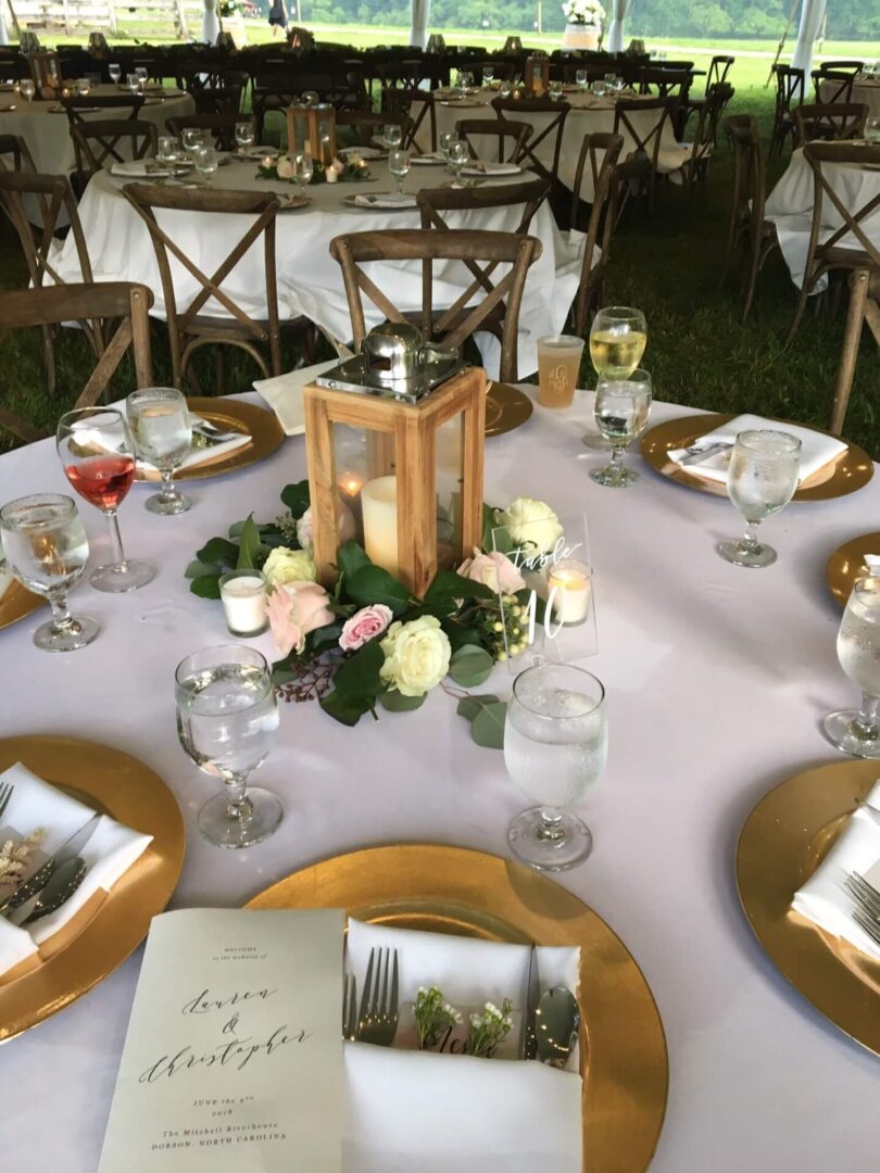 A table set with candles and flowers on top of it.