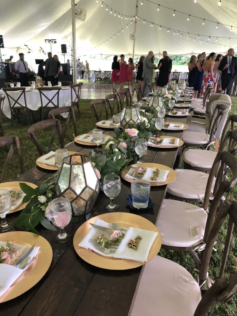 A long table with plates and flowers on it