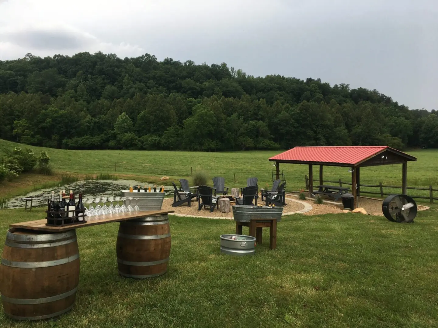 A picnic area with tables and chairs in the grass.