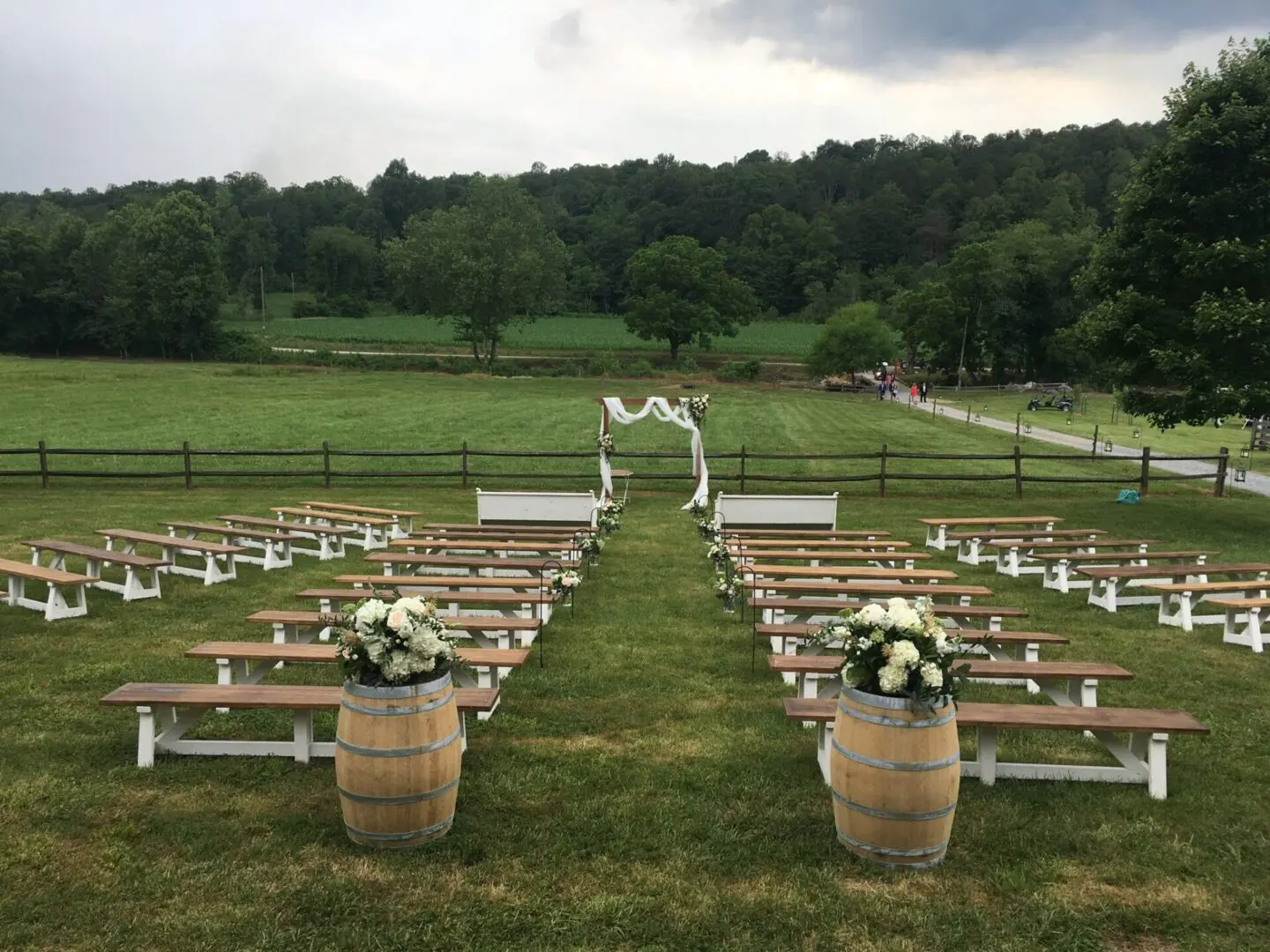 A field with benches and flowers in the middle of it