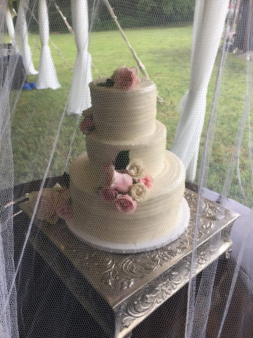 A three layer cake with flowers on top of it.